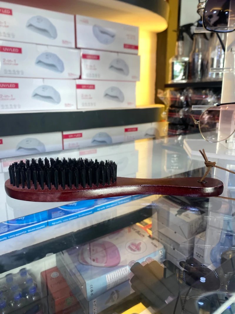 Wooden-handled brush with firm bristles for hair and beard