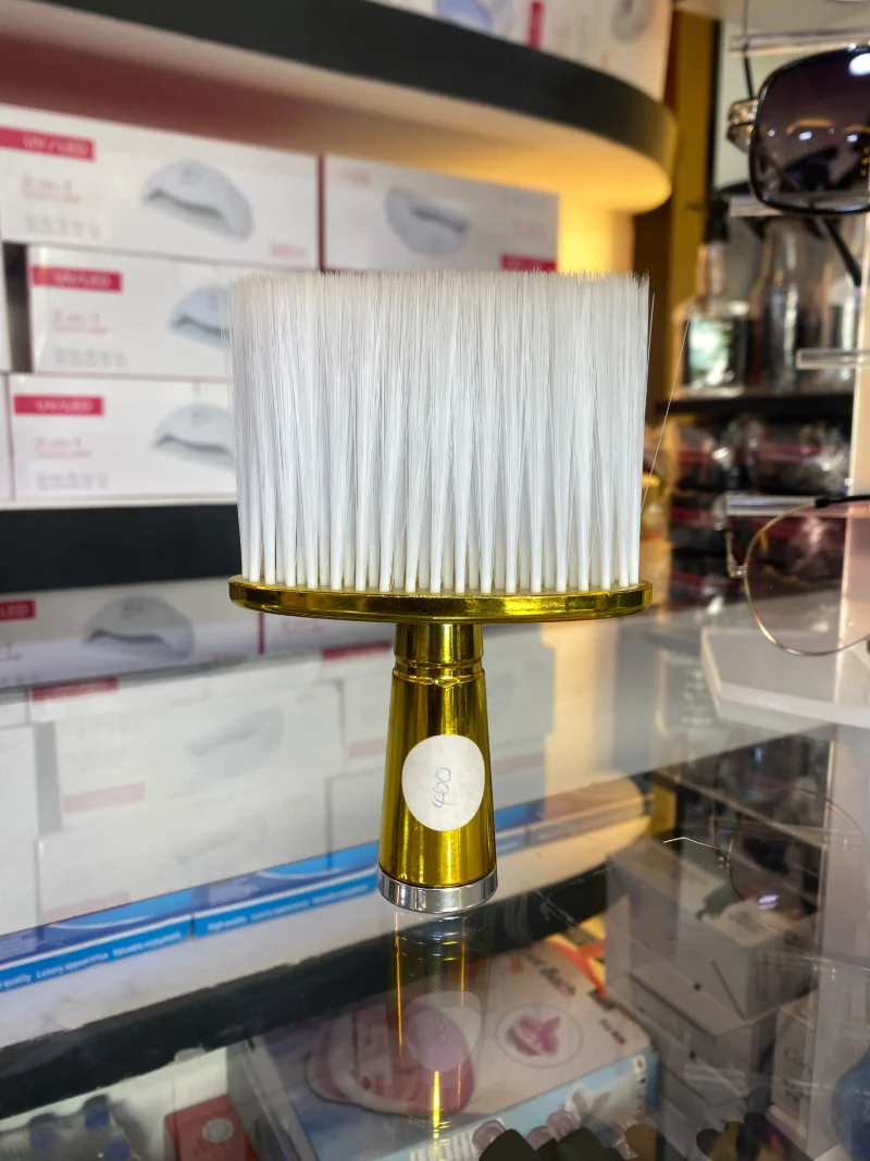 Barber neck brush with white bristles and a gold handle